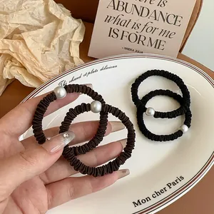 Coleteros elásticos con perla grande en negro y marrón con diseño minimalista
