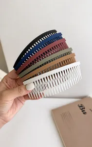 Hand holding 6 colors of matte finish hair side combs for fixing bangs and stray hair