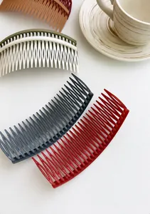 Detailed overhead view of multiple colored curved hair side combs in matte finish