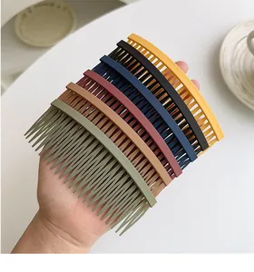 Close-up of matte colorful hair side combs set being held for styling and fixing bangs