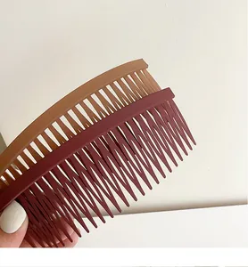 Detail of matte hair side combs in coffee and burgundy colors with multi-tooth design