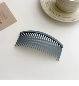 Detailed view of matte dark grey non-slip hair comb for fringe and bangs styling