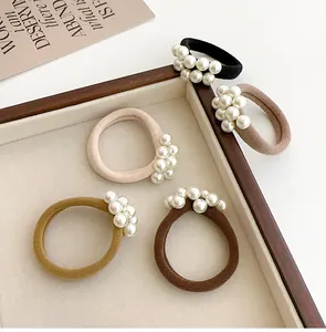 Detail van elastische haarelastiekjes met elegante witte parels in vijf klassieke kleuren