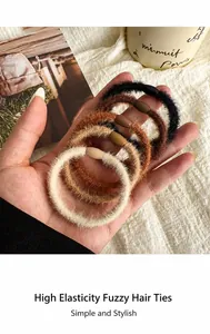 Close-up of plush elastic hair ties in brown tones with smooth decorative buckles