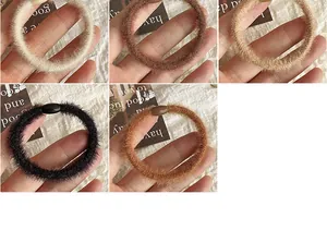 Detail of plush faux fur hair scrunchies in beige and brown with soft texture