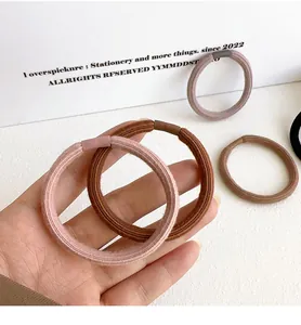Close-up of thick seamless hair ties in earth tones with reinforced elastic texture