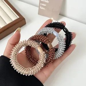 Lot de quatre élastiques spirales résistants en noir, argent, marron et doré champagne