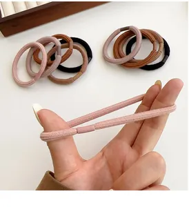 Detail shot showing the high elasticity and seamless design of thick hair ties in Morandi colors