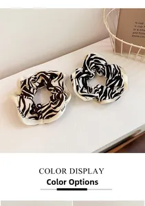 Detail of French zebra print scrunchies in black and brown with Change lettering