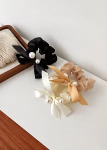 Detailed set of elegant organza bow scrunchies with white pearls in black, beige and gold