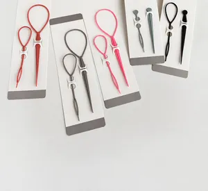 Detail view of 2-piece hair styling tools set including pink and black pull hair needles