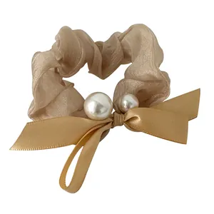 Elegant champagne organza scrunchie with satin bow and pearl accents for women