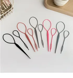 Detail view of 10-piece multi-color hair styling tool set with loop needles on a white desk