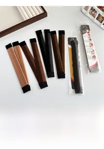 Various colors of bun makers displayed on a white desk with instructions
