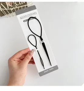 Close-up of black hair styling tool set with large and small loop tools on packaging