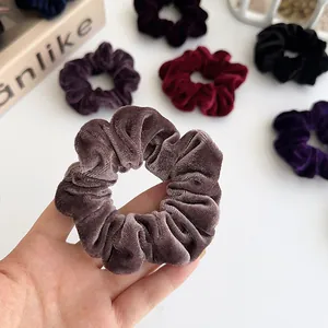 Large velvet scrunchies in various deep colors like burgundy and purple for women