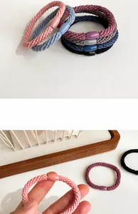 Detail of thick elastic hair ties with smooth oval buckles in assorted muted colors