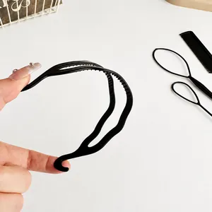 4-piece hair styling set featuring a black resin headband and pull hair tools