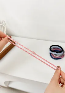 Detail of high-elasticity braided hair tie showing durability and stretch performance