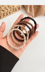 Detail of coffee-colored high elasticity hair ties in a pack of five pieces