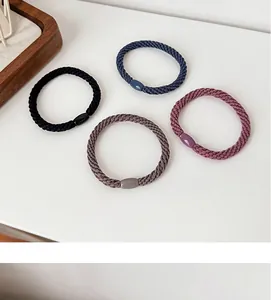 Detail of four high-elasticity braided hair ties in black, navy, purple, and coffee tones