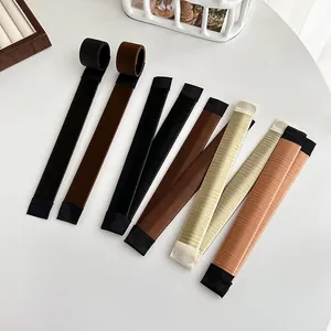 French bun hair maker set in diverse natural hair colors on a clean white table