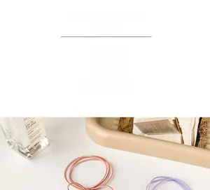 Close-up of high elasticity pastel hair ties on a tray with elegant accessories