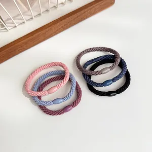 Set of six high-elasticity braided hair ties in six neutral colors on a white surface
