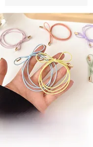 Detailed close-up of colorful candy-toned bow hair ties with gold metal accents