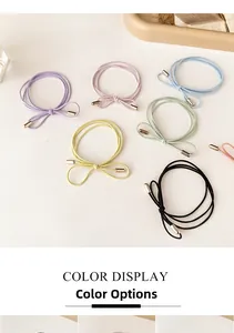 Detail of candy-colored elastic hair ties with bow shape and gold metal end caps