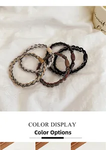 Detailed view of elastic woven hair ties in earth tones with smooth oval resin buckles