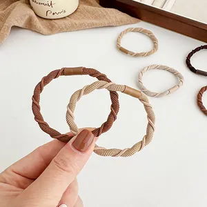 Elastic braided hair ties in coffee and beige tones with a spiral texture for women
