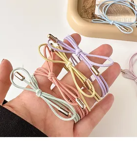 Close-up of macaron color multi-strand elastic hair ties with gold metal buckles