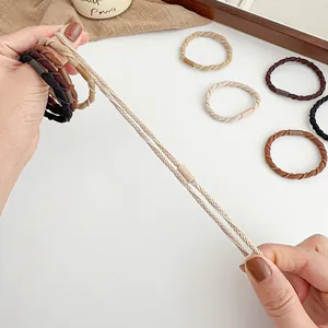 Elastic spiral hair ties in earth tones showing strong stretch and durability for ponytails