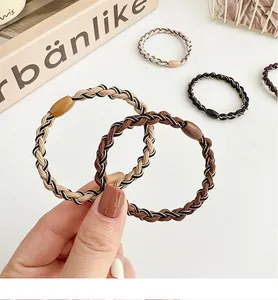 Detailed view of elastic woven hair ties in earth tones with stylish resin resin beads