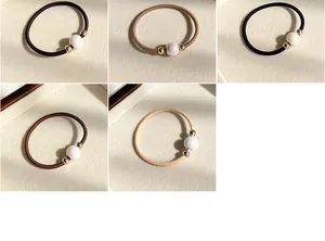 Detail of high-elastic pearl hair ties in five colors including coffee and black shades