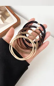 Detailed close-up of high-elasticity braided hair ties with elegant gold metal buckles