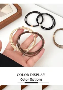 Detailed view of elastic hair ties in milk tea colors with rose gold metal clasps