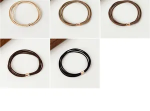 Detailed macro view of high-elastic multi-strand hair ties with gold metal buckles