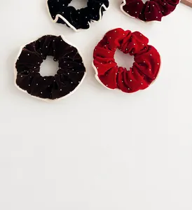 Detail of velvet scrunchies with elegant light piping and sparkling crystal beads