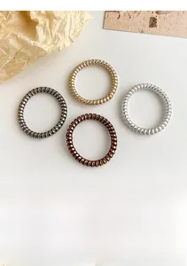 Detailed set of four metallic spiral hair ties in black gold brown and silver tones
