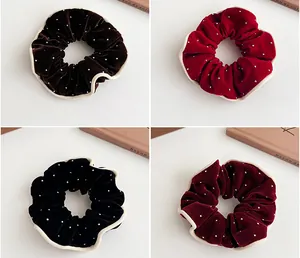Macro detail of French velvet scrunchies with silver beads and wave edge design