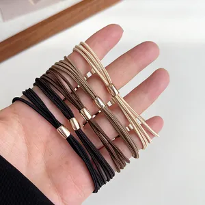 Elastic four-in-one hair ties in earth tones with gold metal buckle detail
