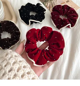 Close-up of velvet scrunchies with bead embellishments and contrast piping edges
