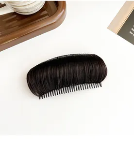 Macro view of dark brown hair volumizing insert comb with natural synthetic fibers