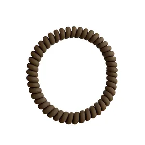 Elastic matte spiral hair coil in dark coffee brown finish on a white background