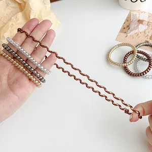 Spiral elastic hair ties in neutral colors shown with high stretch durability on white background