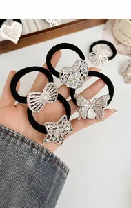 Detail of black elastic hair bands with rhinestone butterfly, heart, and pearl charms