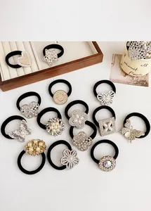 Detailed view of elastic hair ties with rhinestone butterflies and pearl charms