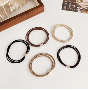Close-up of five-piece rhinestone hair ties set in coffee tones on white background